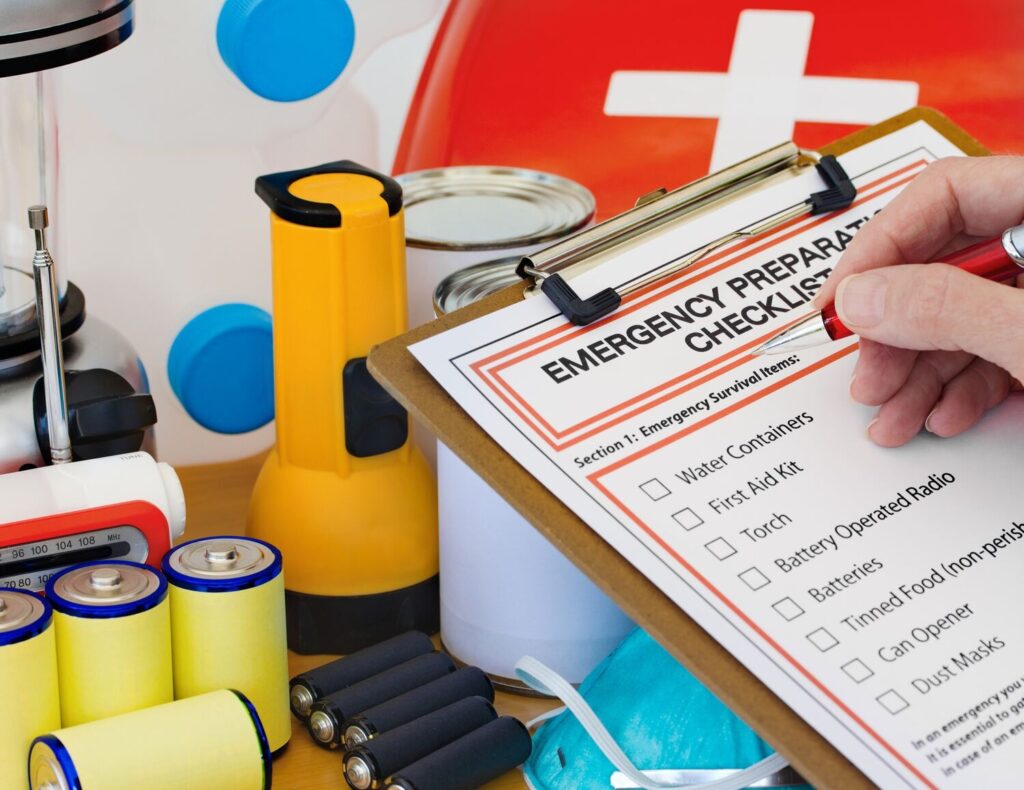 Close-up of emergency preparedness checklist with survival kit items